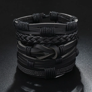 Detail of multi-layer black braided leather bracelets with textured rope cords and knots