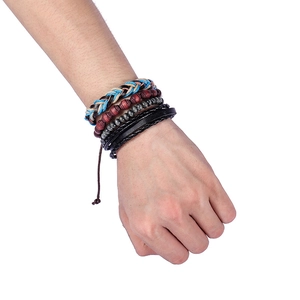 Detail of bohemian multilayer bracelet with woven ropes, wooden beads and leather cords