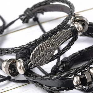 Multilayer black leather bracelet set featuring vintage silver wing pendant and metal beads