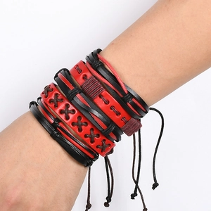 Detail of multilayer punk leather bracelet with red and black braided ropes on wrist