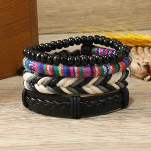 Bohemian multicolored beaded and woven bracelets set for women on natural wood background