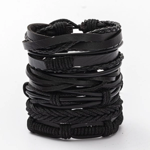 Detail shot of multi-layer black braided leather bracelets set for men with punk style