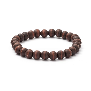 Macro view of handmade wooden beaded bracelet showing natural rosewood grain and texture