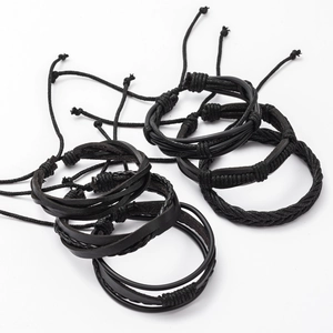 Detailed close-up of multi-layer black braided leather bracelets with adjustable knots