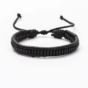 Detail of black braided leather bracelet for men featuring an adjustable cord closure