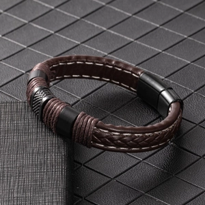 Close-up of men's braided leather bracelet with black brushed metal magnetic clasp