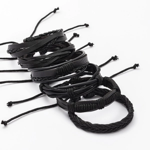 Detailed close-up of a set of 6 adjustable black leather and braided fiber men's bracelets