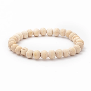 Macro detail of natural round wooden beads showing smooth texture and organic fiber patterns