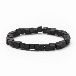 Close-up of minimalist black square wooden beads on a woven men's cord bracelet