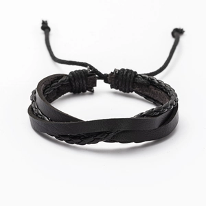 Detail of multi-layered black braided leather bracelet for men with adjustable cord knot