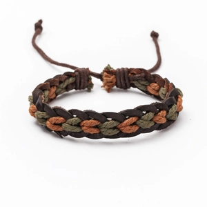 Detail of woven brown leather and green cotton cord bracelet with adjustable knot
