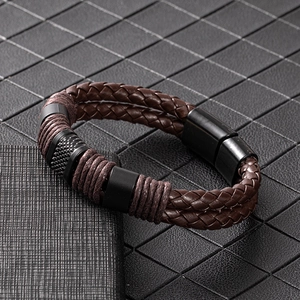 Close-up of double-layered braided leather bracelet with magnetic metal clasp and texture