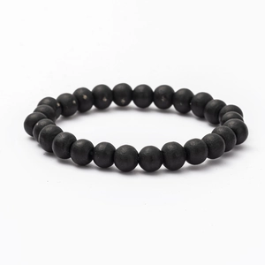 Detail shot of black round beaded bracelet with matte finish on a clean white background