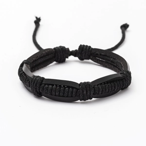 Detail of hand-woven black leather bracelet with adjustable cord and punk style texture