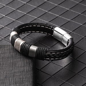 Detail of men's black braided leather bracelet with stainless steel magnetic clasp