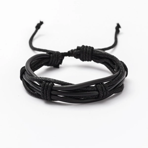 Detail of black multi-layer braided leather bracelet with adjustable knotted closure