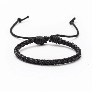 Close-up of black braided leather bracelet with adjustable knot cord detail