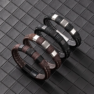 Detail of four-piece men's braided leather bracelet set with magnetic metal clasps