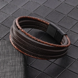 Detail of multi-layer woven leather bracelet with matte black magnetic clasp