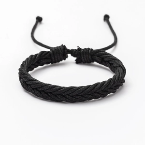 Detailed view of adjustable black braided leather bracelet with multi-strand fiber textures