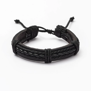 Close-up of black multilayer leather bracelet showing braided texture and adjustable knots
