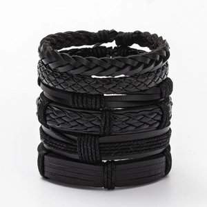 Close-up of black multilayer braided leather bracelets with various weave textures