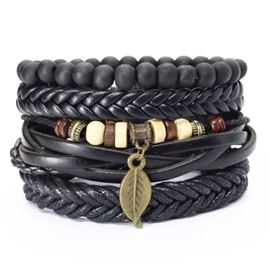 Close-up of multilayered black leather bracelet with retro bronze metal leaf pendant