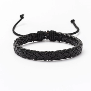 Detailed view of handmade black braided leather bracelet with adjustable drawstring knot