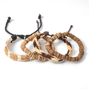 Detail of four-piece set bohemian braided leather bracelets with adjustable wooden beads