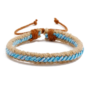Detailed close-up of handmade woven hemp rope bracelet with light blue fiber core