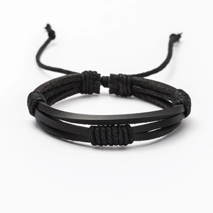 Macro detail of multi-layer black braided leather bracelet with adjustable knot closure