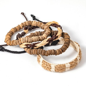 Detail of woven leather and wood bead bracelet set with ethnic bohemian patterns