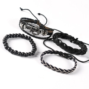Set of four men's black leather anchor bracelets with braided cords and matte beads