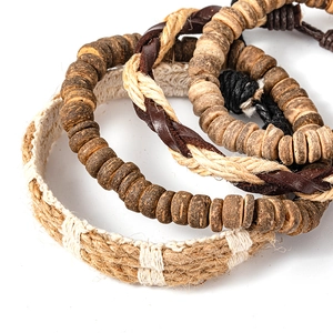 Close-up of handmade bohemian bracelet set with wooden beads and braided leather cords
