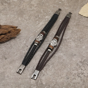 Men's leather woven bracelets with sun and moon silver charms on marble background