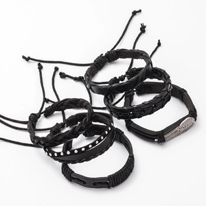 Close-up of a 6-piece men's black leather bracelet set with woven ropes and feather charm