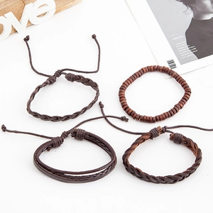 Set of four vintage multi-layer leather bracelets with wooden beads on white background