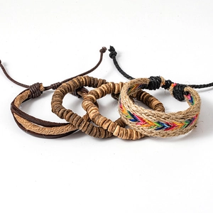 Detail of four handmade bohemian bracelets with braided hemp and coconut shell beads