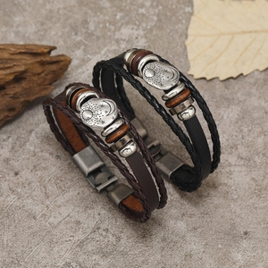Detailed macro shot of vintage multilayer braided leather bracelet with sun moon star charm