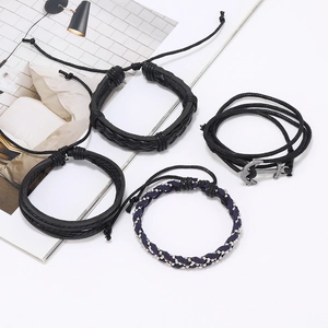 Close-up of four-piece men's leather bracelet set with anchor charm and blue beads