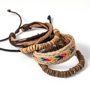 Detail of ethnic multi-layer bracelet set featuring leather, hemp rope and wooden beads