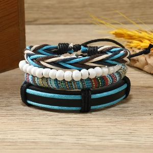 Détail de bracelets de style bohème empilables sur bois clair avec fleurs séchées