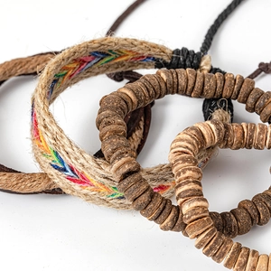 Close-up of handmade ethnic braided bracelets with colorful threads and coconut shell beads