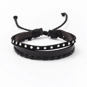 Detail of black multi-layer leather bracelet with silver rivets and adjustable cord