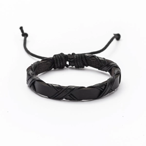Detail of black woven leather bracelet showing multi-layer punk style and braided texture