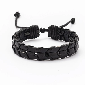 Detail of hand-woven black leather bracelet showing texture and adjustable cord closure