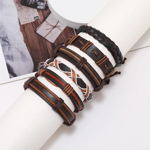 Six-piece set of men's vintage leather braided bracelets displayed on a wooden table