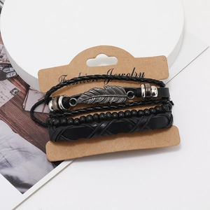 Men's retro layered leather bracelet set with feather charm on a minimalist display