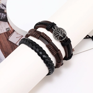 Close-up of vintage multilayer braided leather bracelet set with tree of life metal charm
