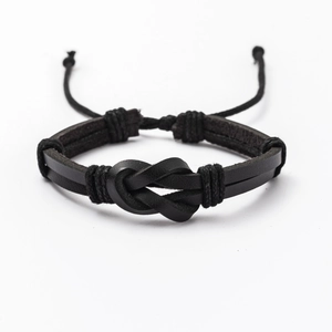 Detail of men's black braided leather bracelet with knotted design and adjustable cord